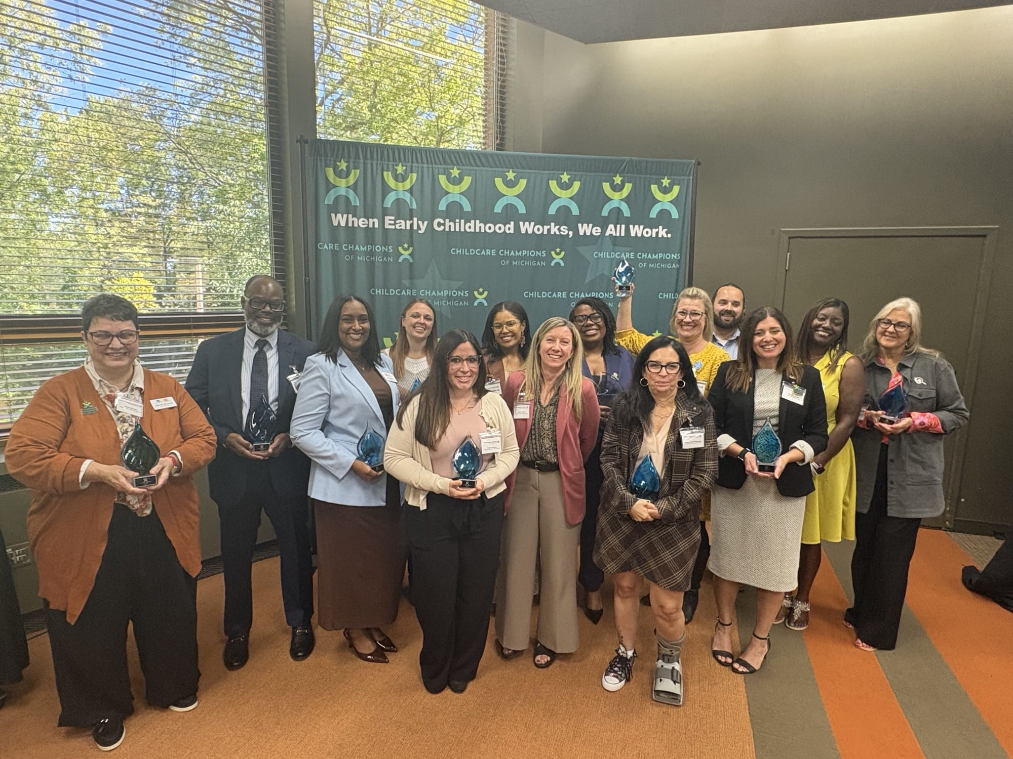 Winners pose with their awards at the 2026 Child Care Champions ceremony in East Lansing