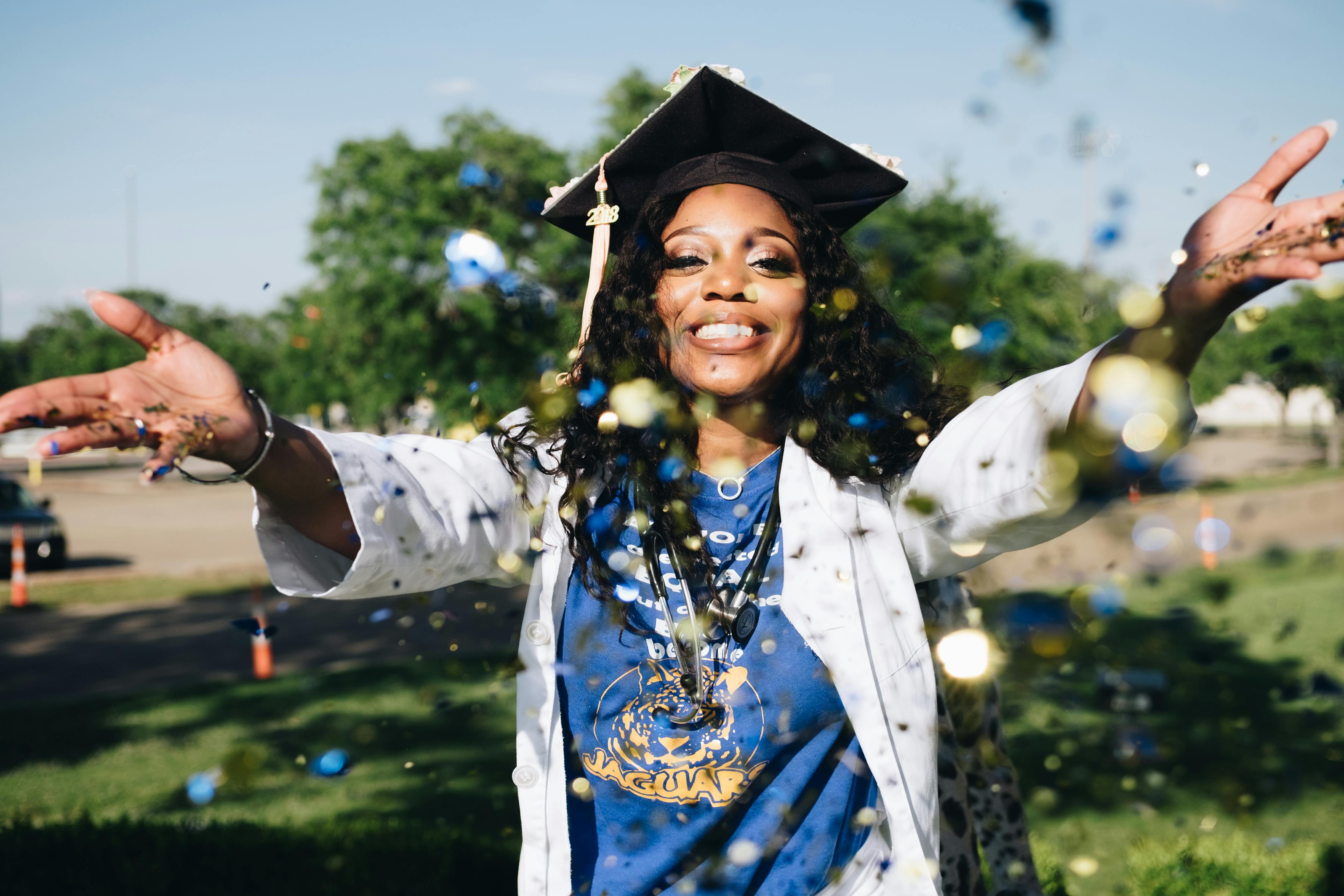 Nursing Graduate throwing confetti