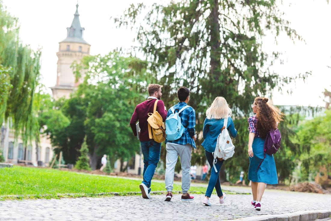 Students walking outdoors college campus