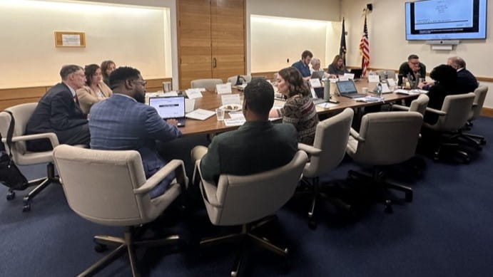 Members of ACTS sitting at a conference table
