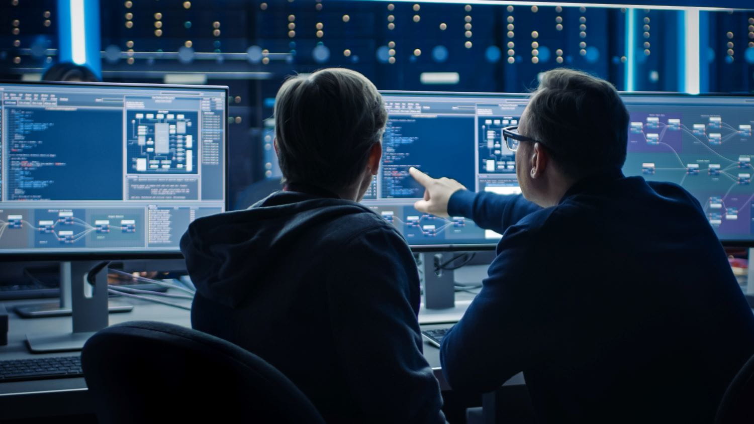 Two individuals sitting at a computer
