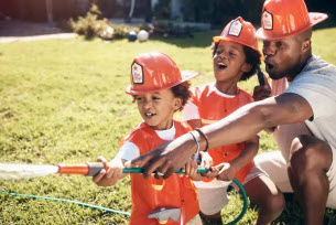 dad with kids playing firemen