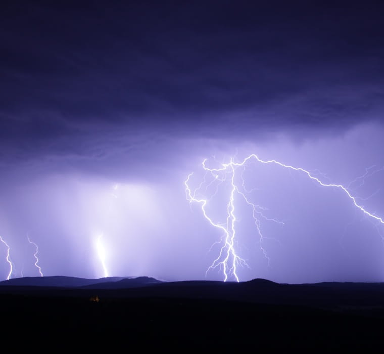 Impressive lightning framed against a purple-hued storm