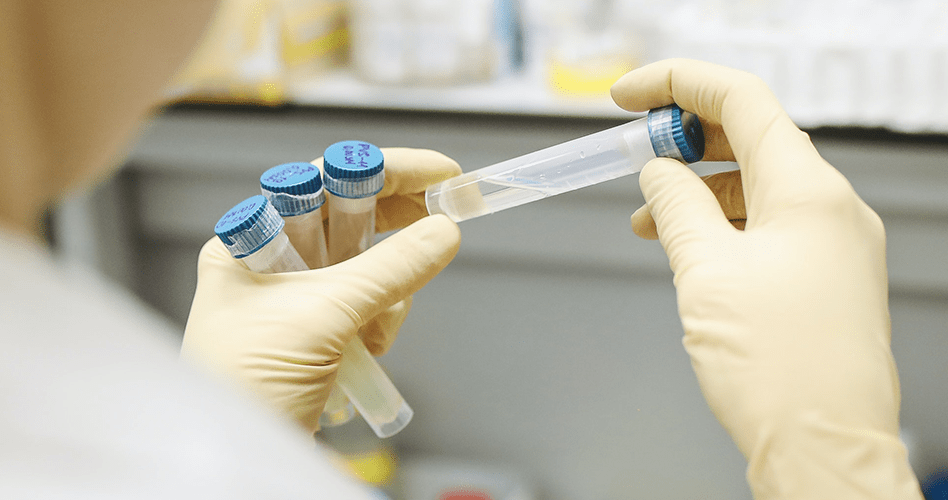 Scientist Holding Test Tubes