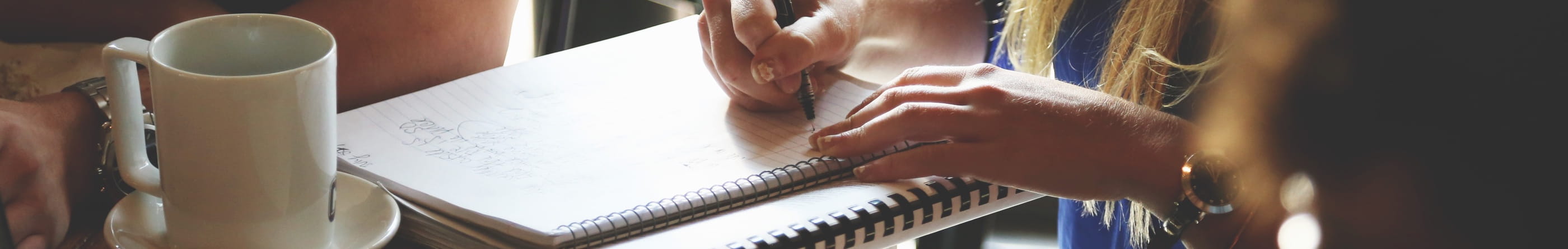 A woman writing in a notebook