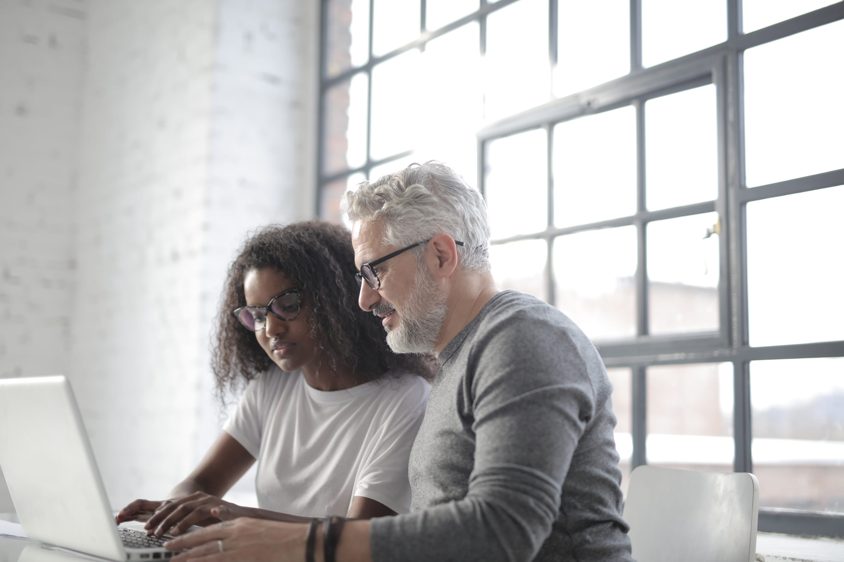 Two people working on a computer.