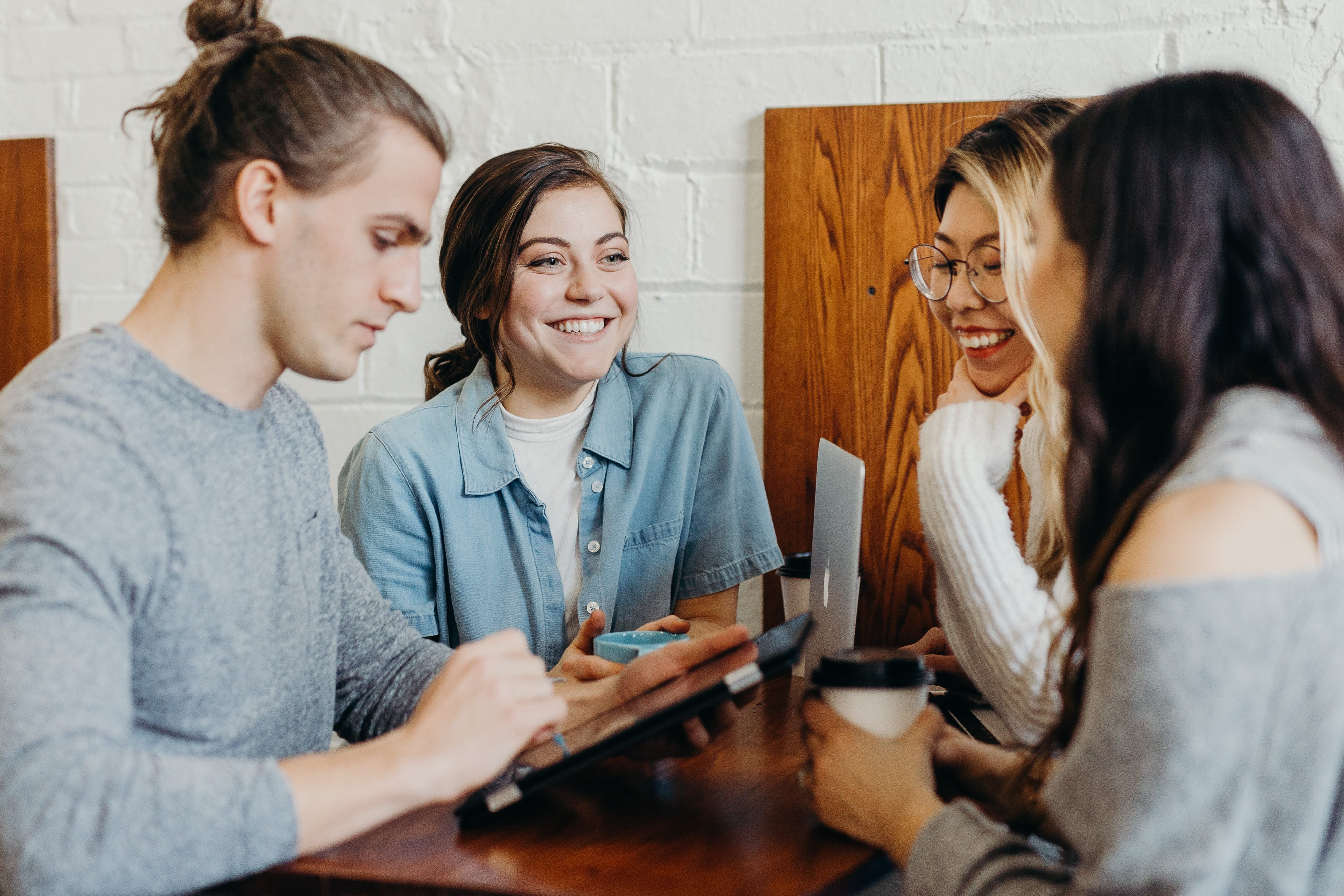A group of students sitting at a table talking. 