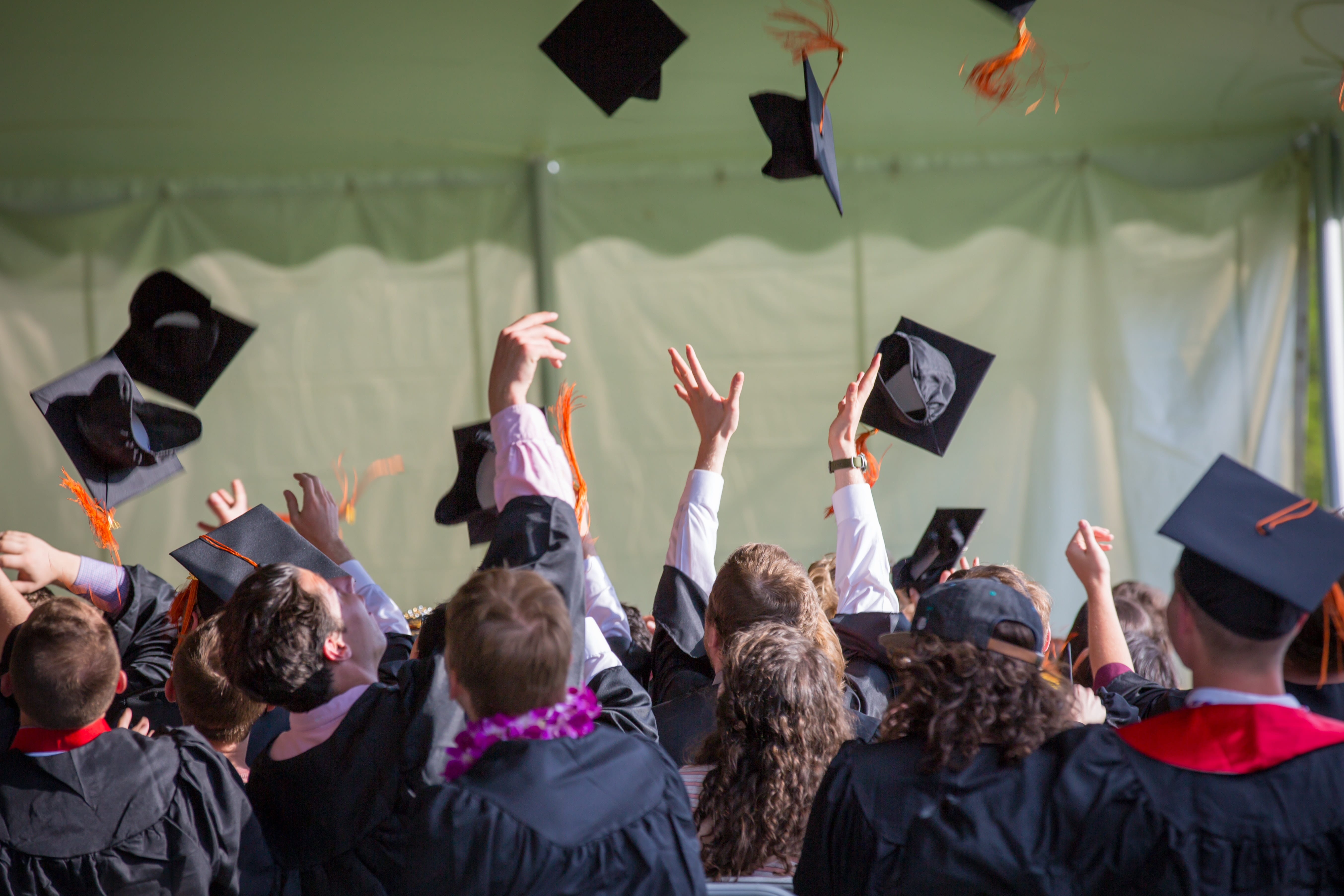 A photo of students throwing their graduation caps.