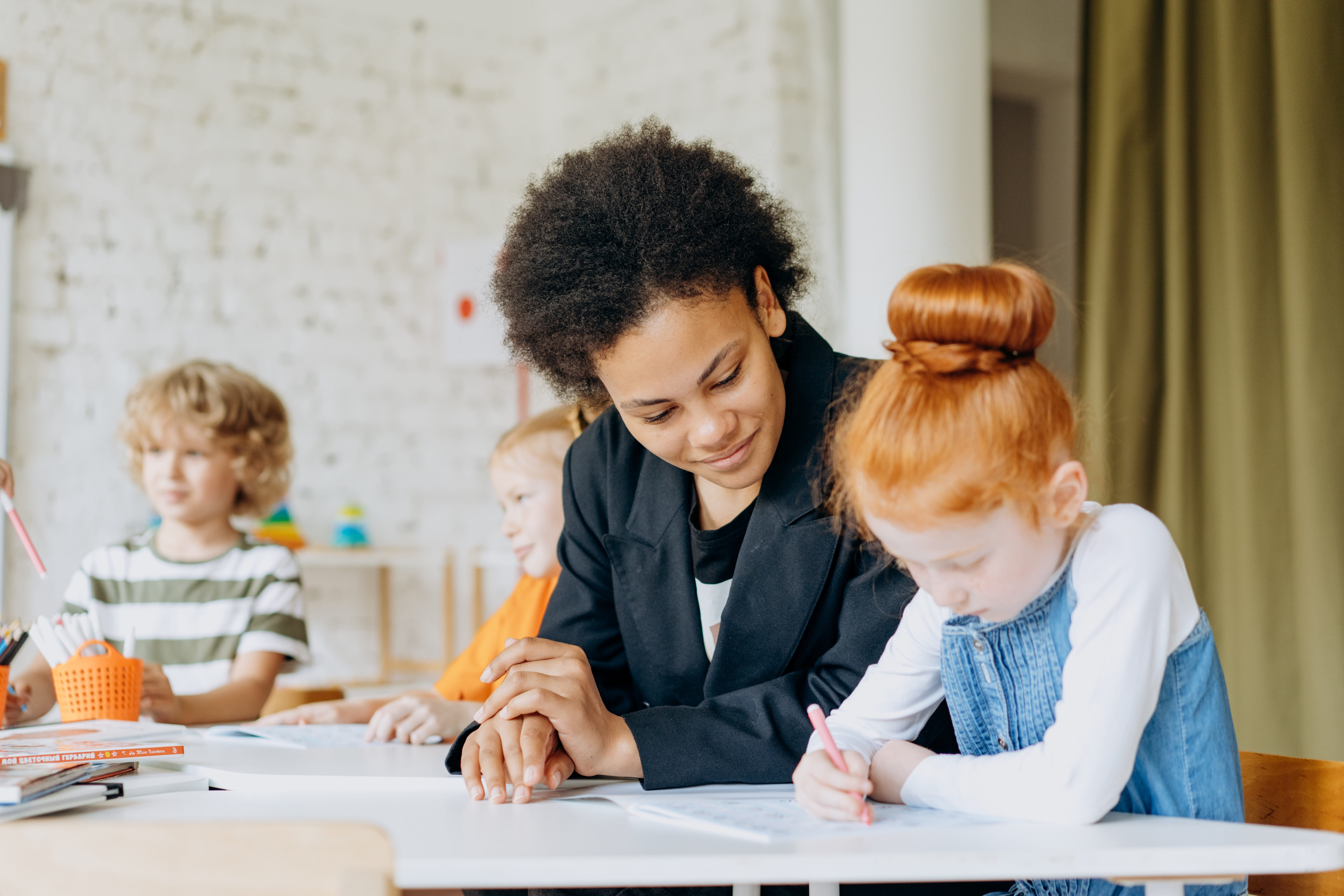 A teacher sitting with her student.