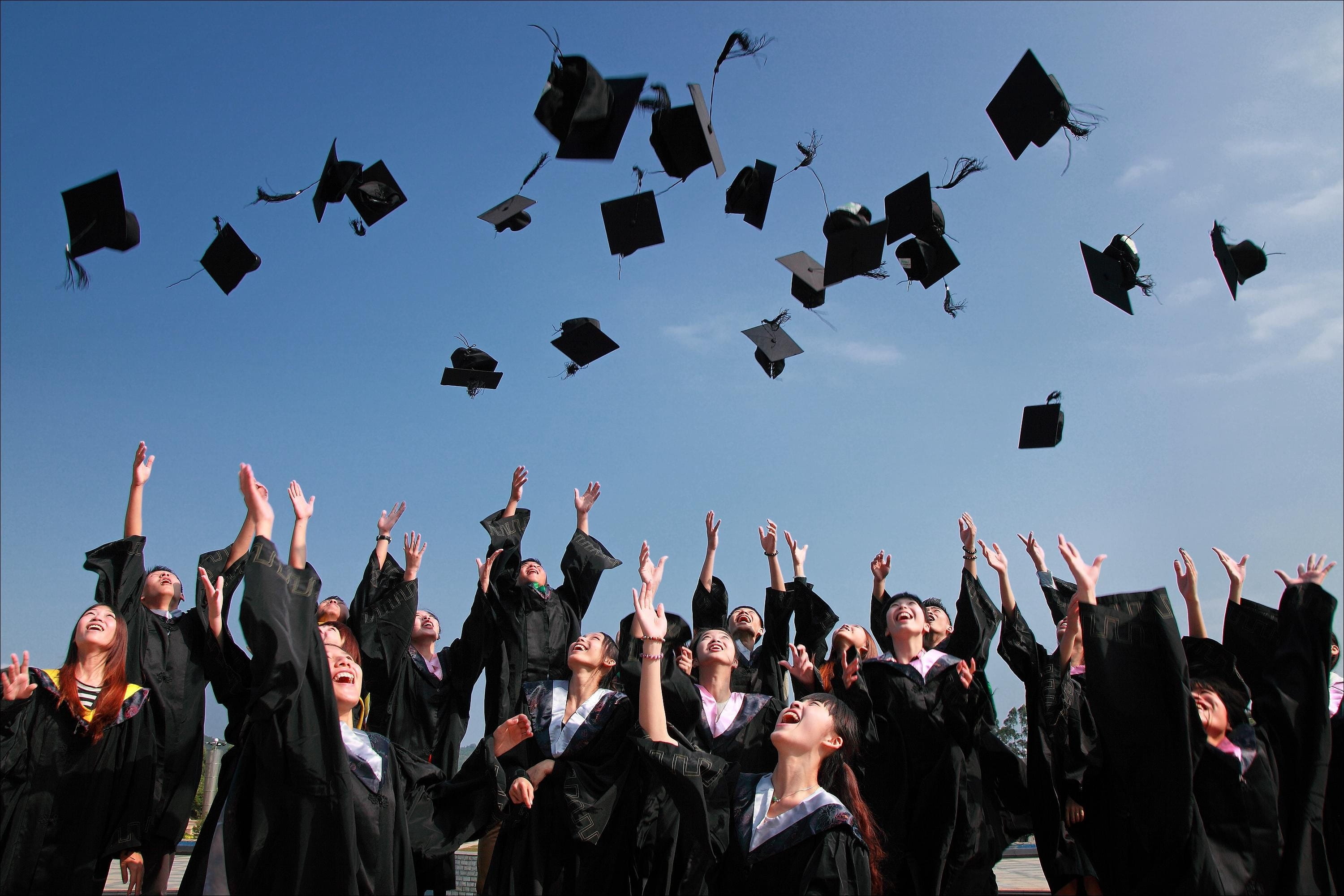 Students throwing their caps at graduation.
