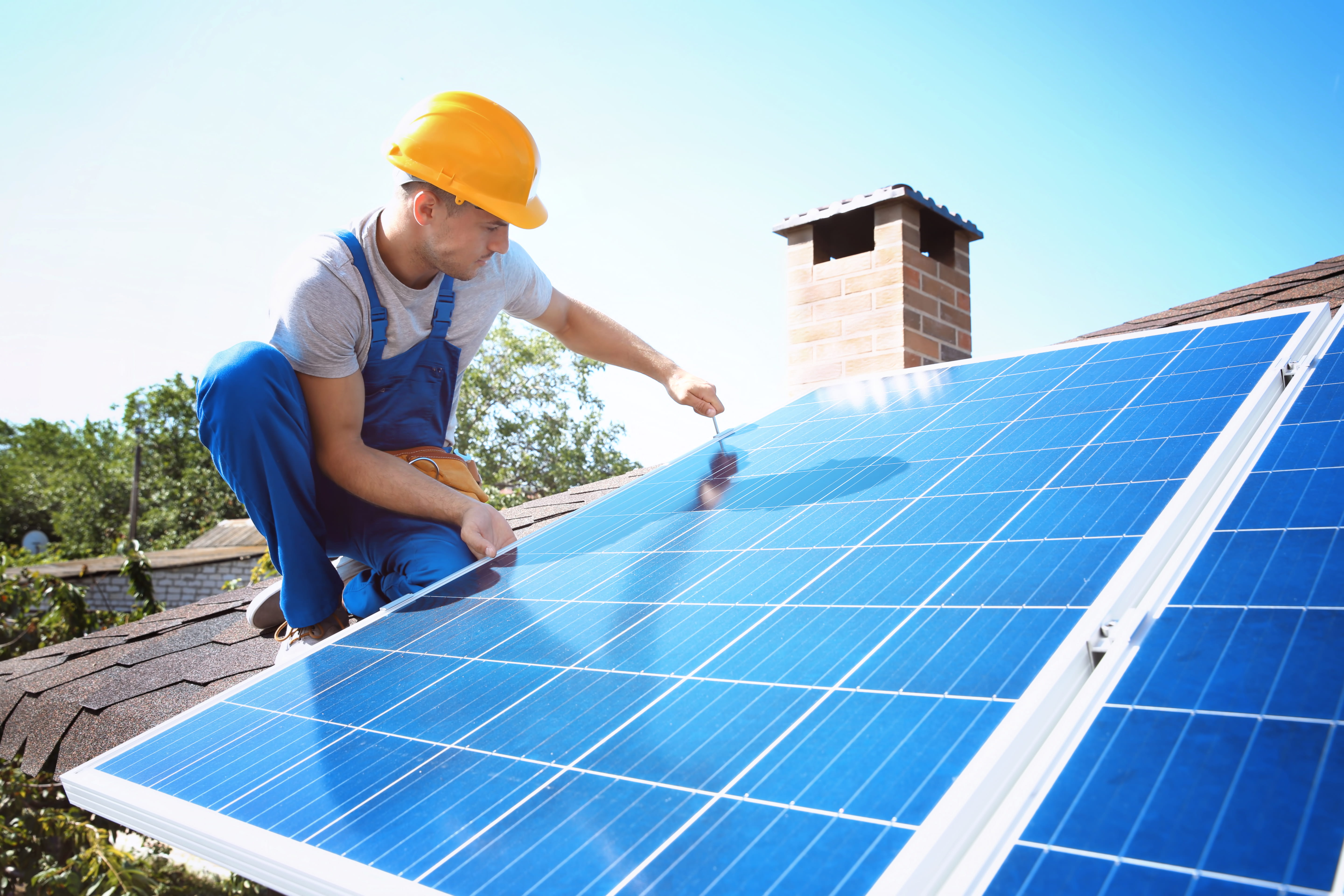 Contractor installing solar panels on roof