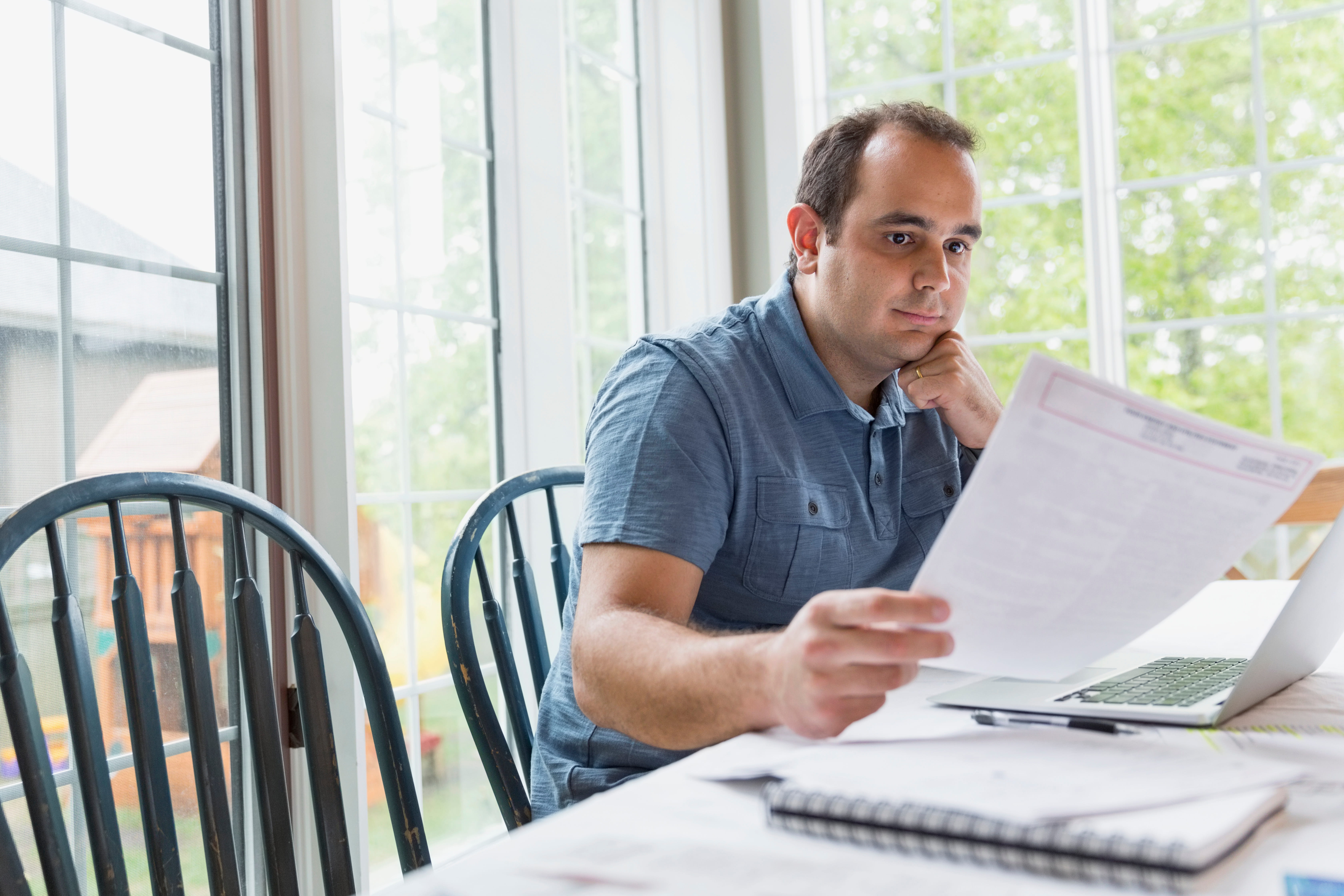 Man using laptop to pay bills