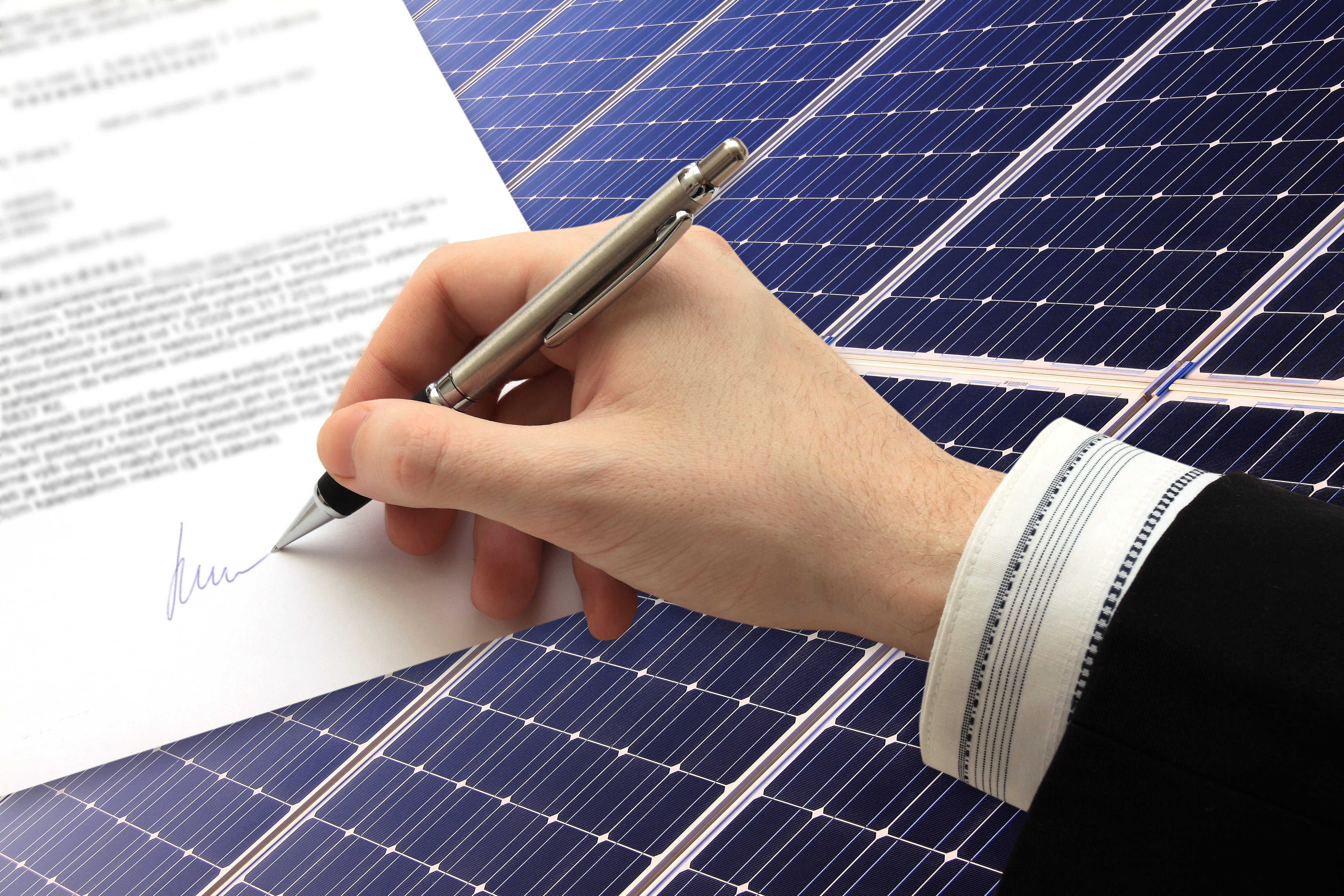 Signing a lease in front of solar panels