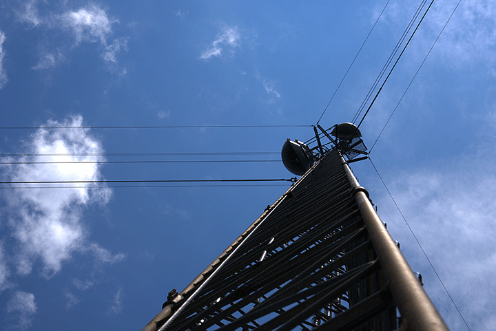 Upward view of tower showing guy wires