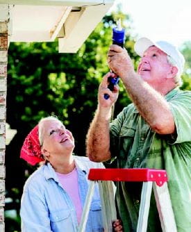 elderly couple performing home repairs