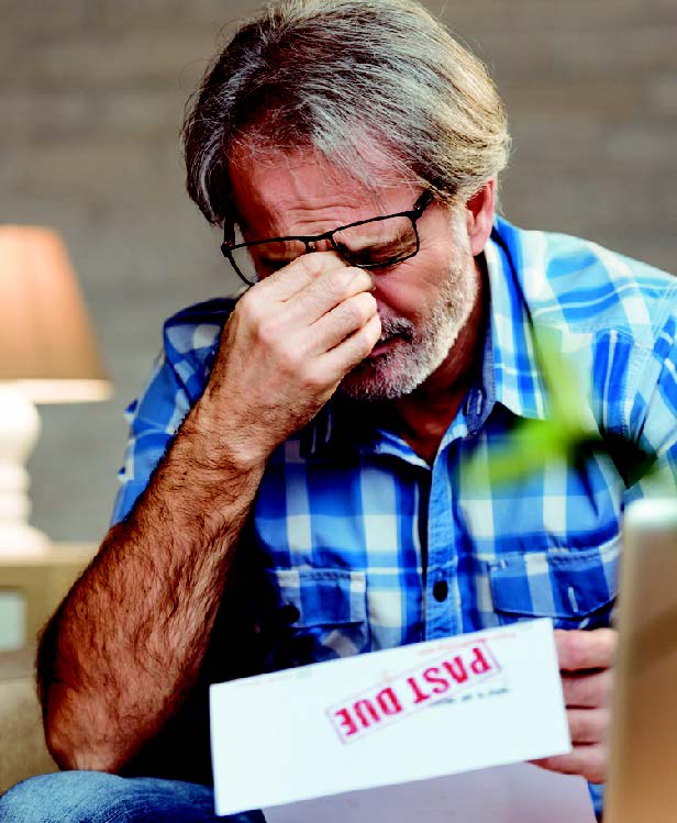 stressed man holding bills