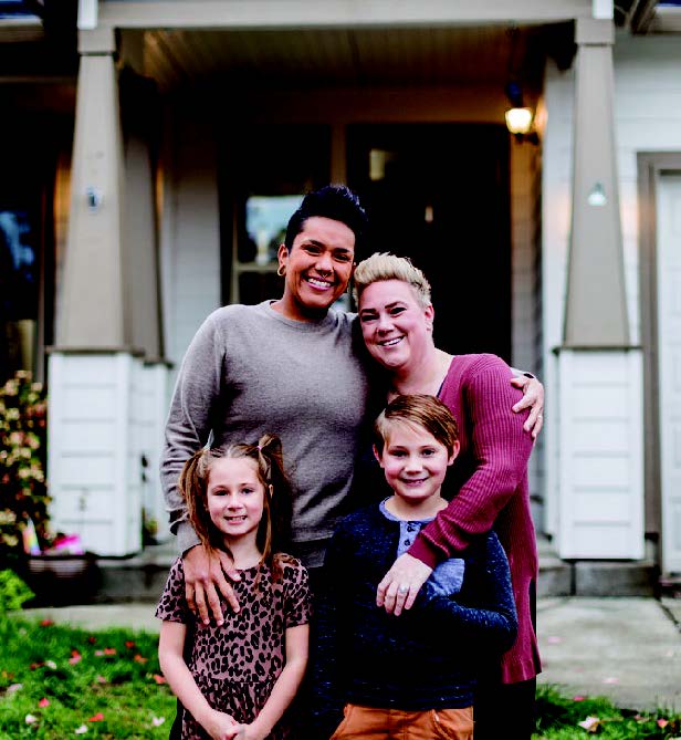 family in front of a house