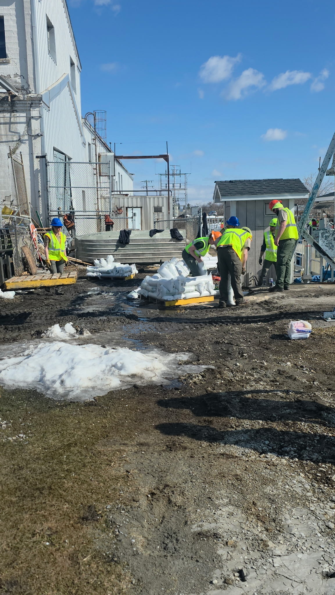 Workers putting sandbags along the dam.