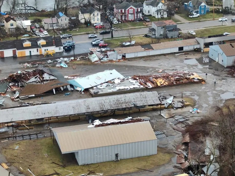 An aerial view of damaged buildings after a tornado. 