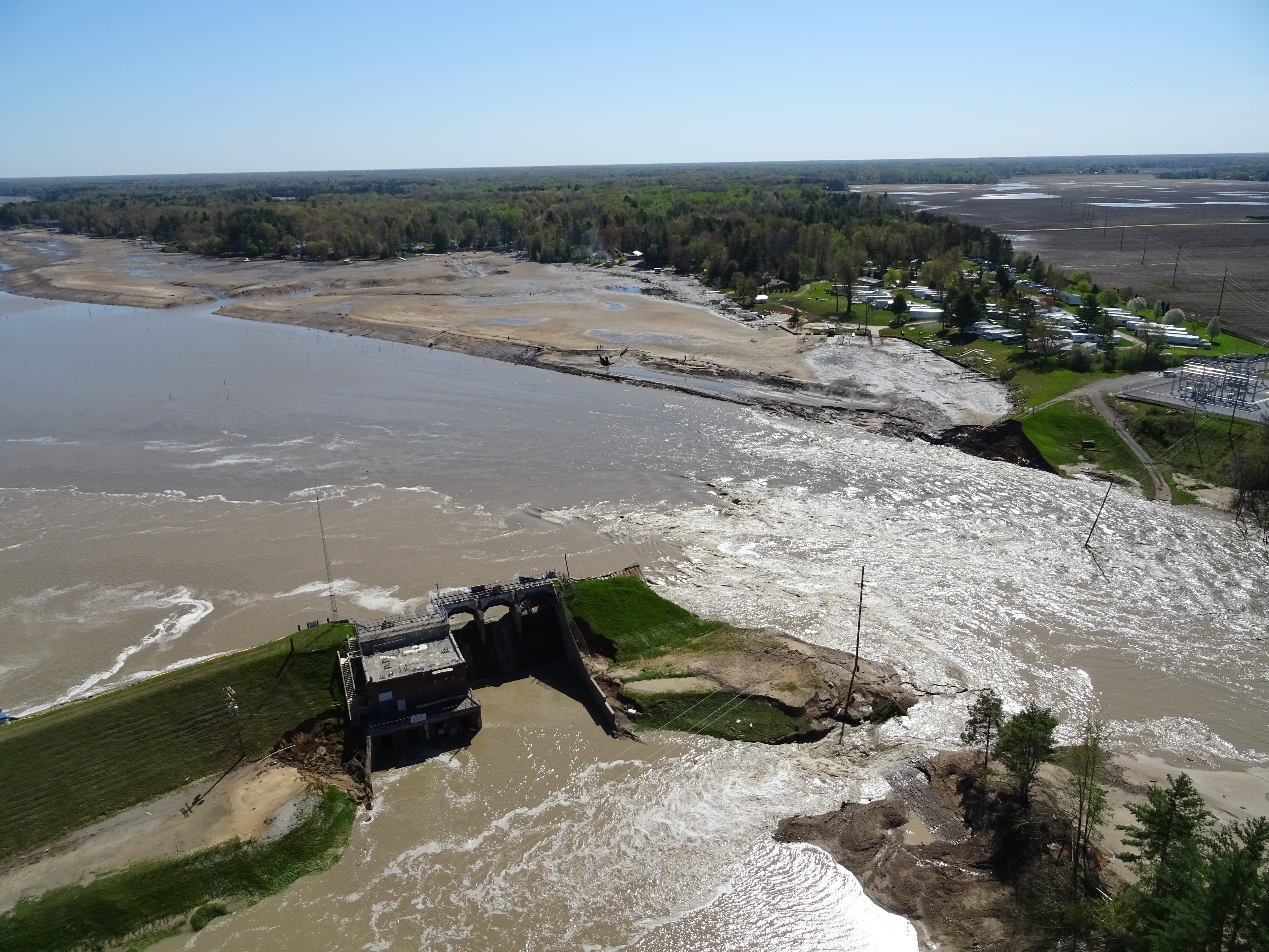 An aerial view of a broken dam. 