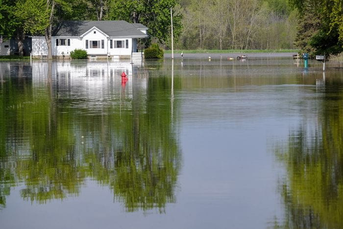 A house surrounded by flood water. 