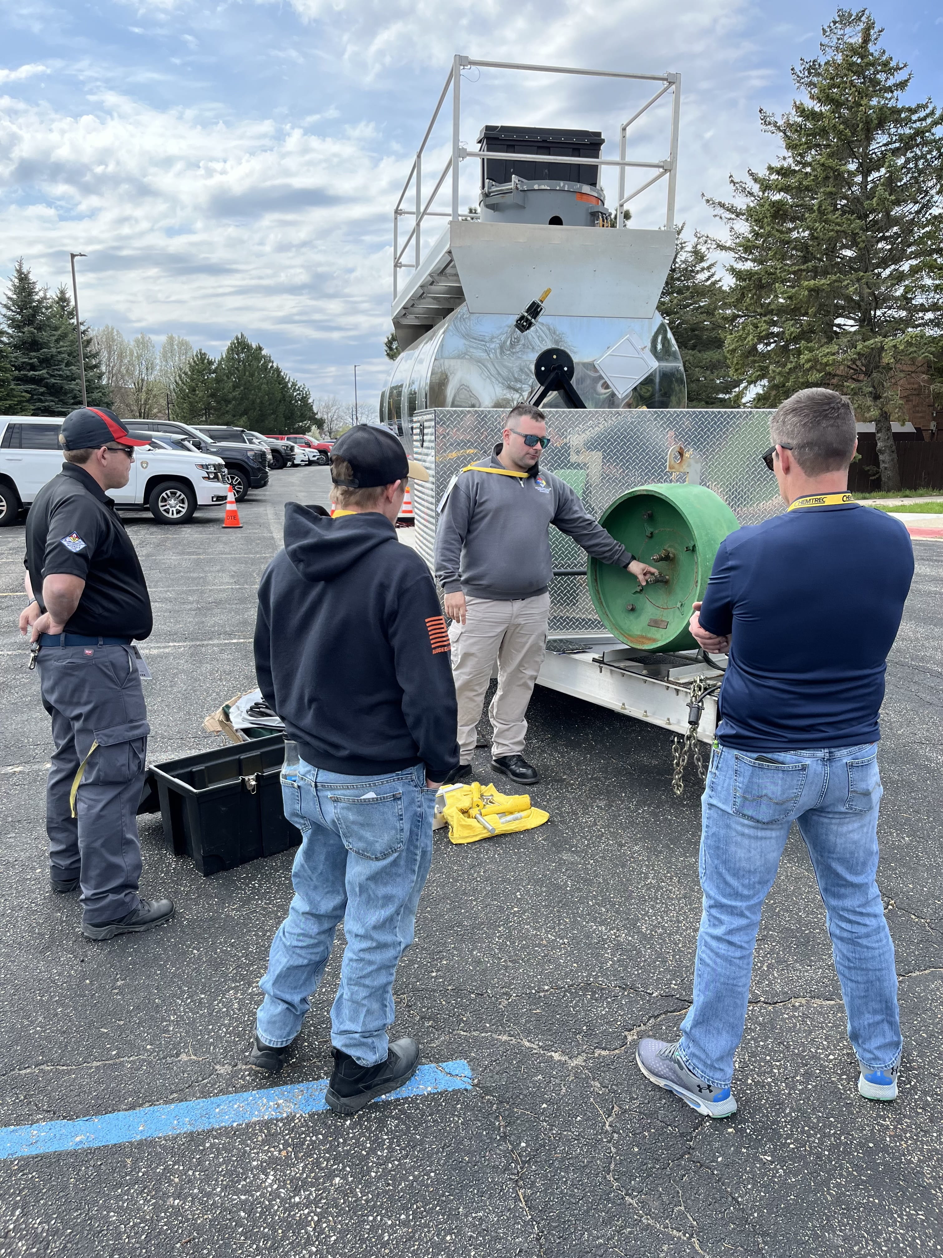 People gathered around an instructor outdoors at the Michigan Hazmat Responder Conference.