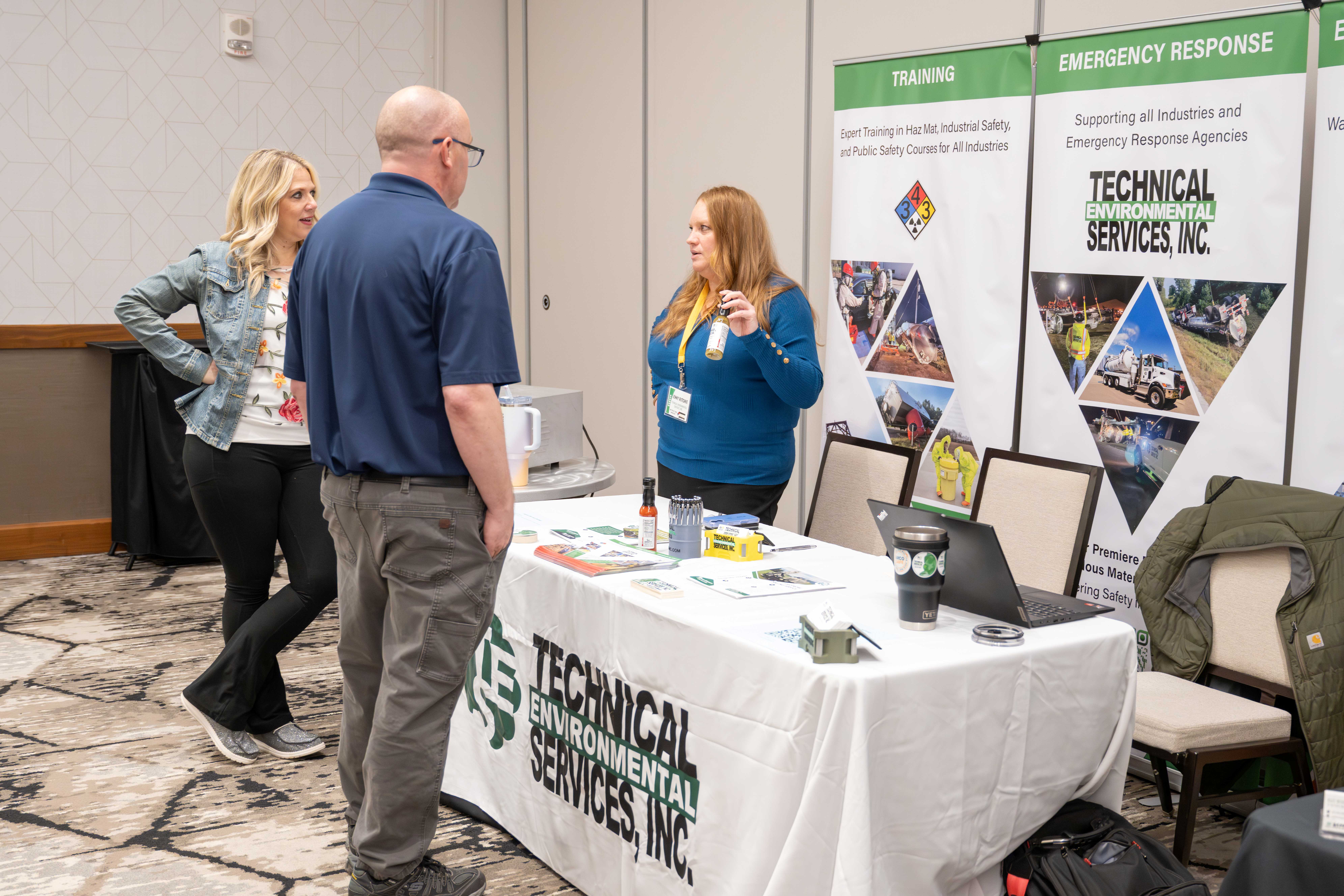 People standing at the Technical Environmental Services booth at the 2025 MI Hazmat Responder Conference. 