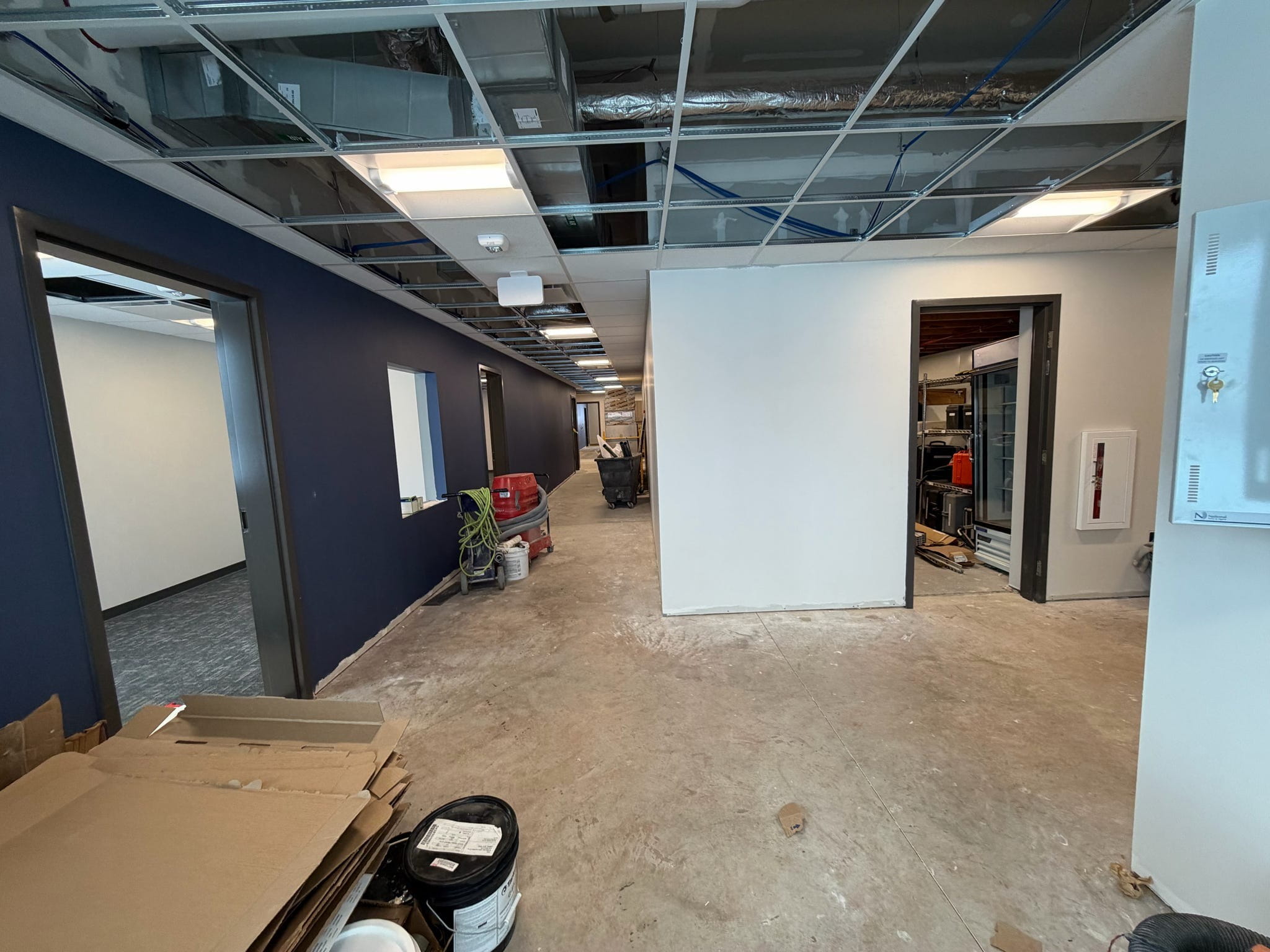 The building lobby, nearly complete but with exposed ceilings and unfinished flooring.