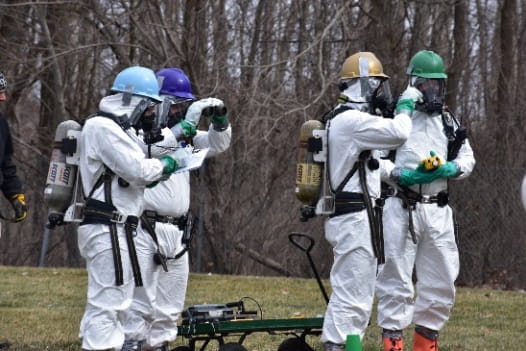 People in hazmat suits training