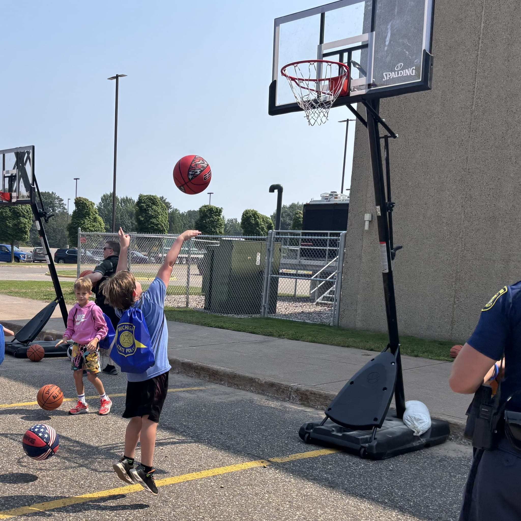 Child shooting a basketball. at an outdoor hoop. 
