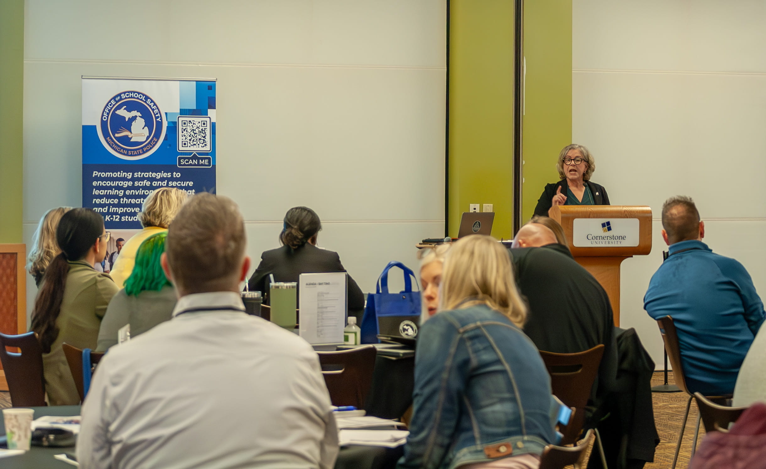 Kim Root speaking to audience at Office of School Safety
