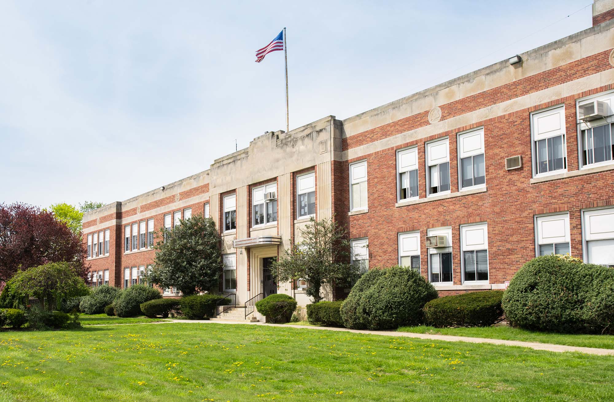 Old School Building  outside with flag on top of building