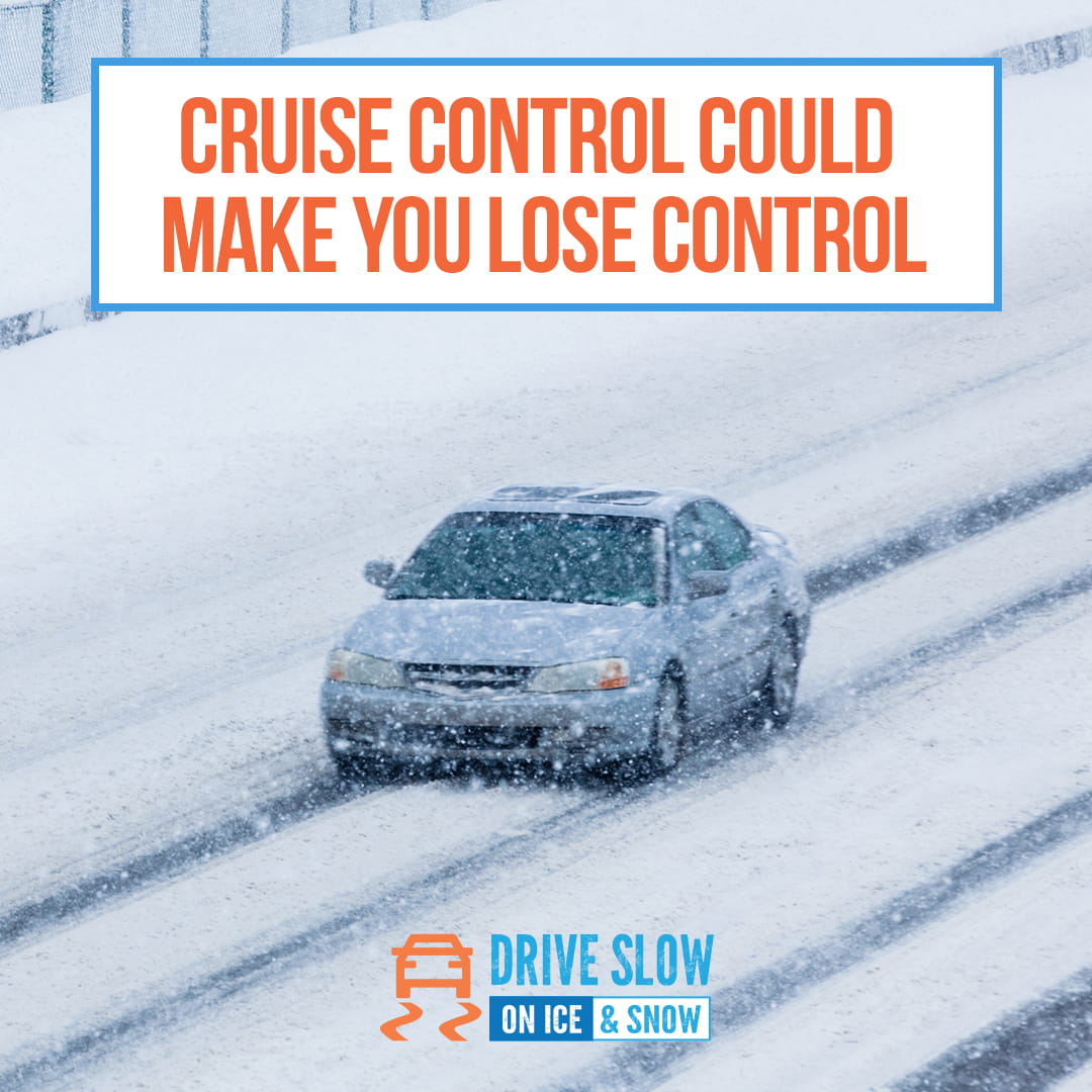 car driving in tire tracks in snow storm