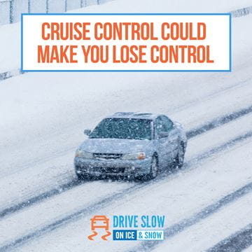 car driving in tire tracks in snow storm