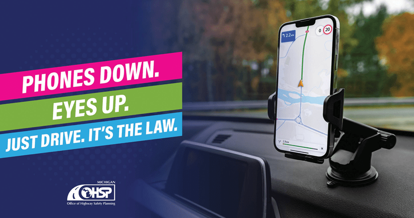 cell phone in phone cradle on dash.