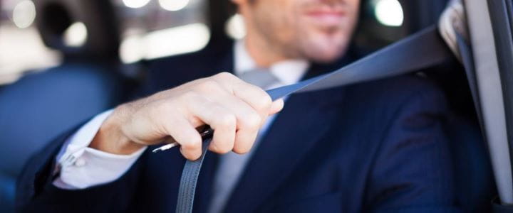 Man putting on seat belt