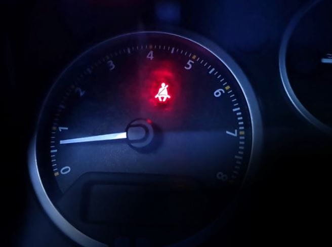 seat belt warning light on a dashboard