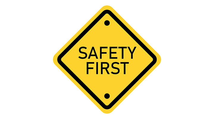 Bright yellow safety first sign. 