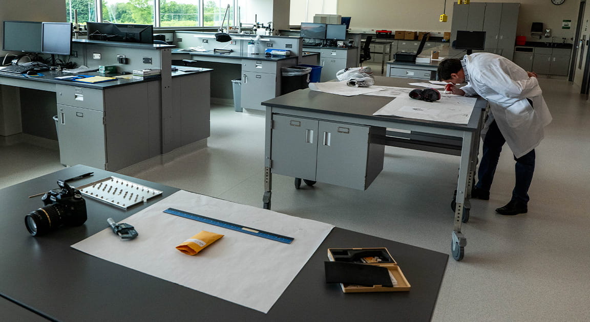 Forensic scientist working in lab.
