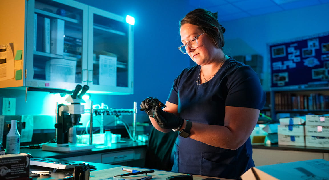 Civilian forensic scientist working in lab. 