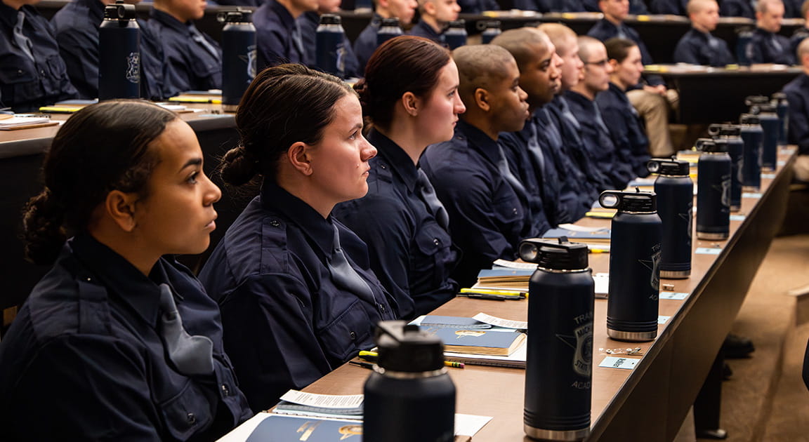 Trooper recruits sit in the auditorium on the first day of recruit school. 
