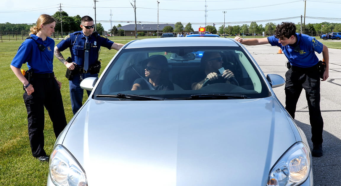 Youth Trooper Explorers training with troopers to make a traffic stop. 