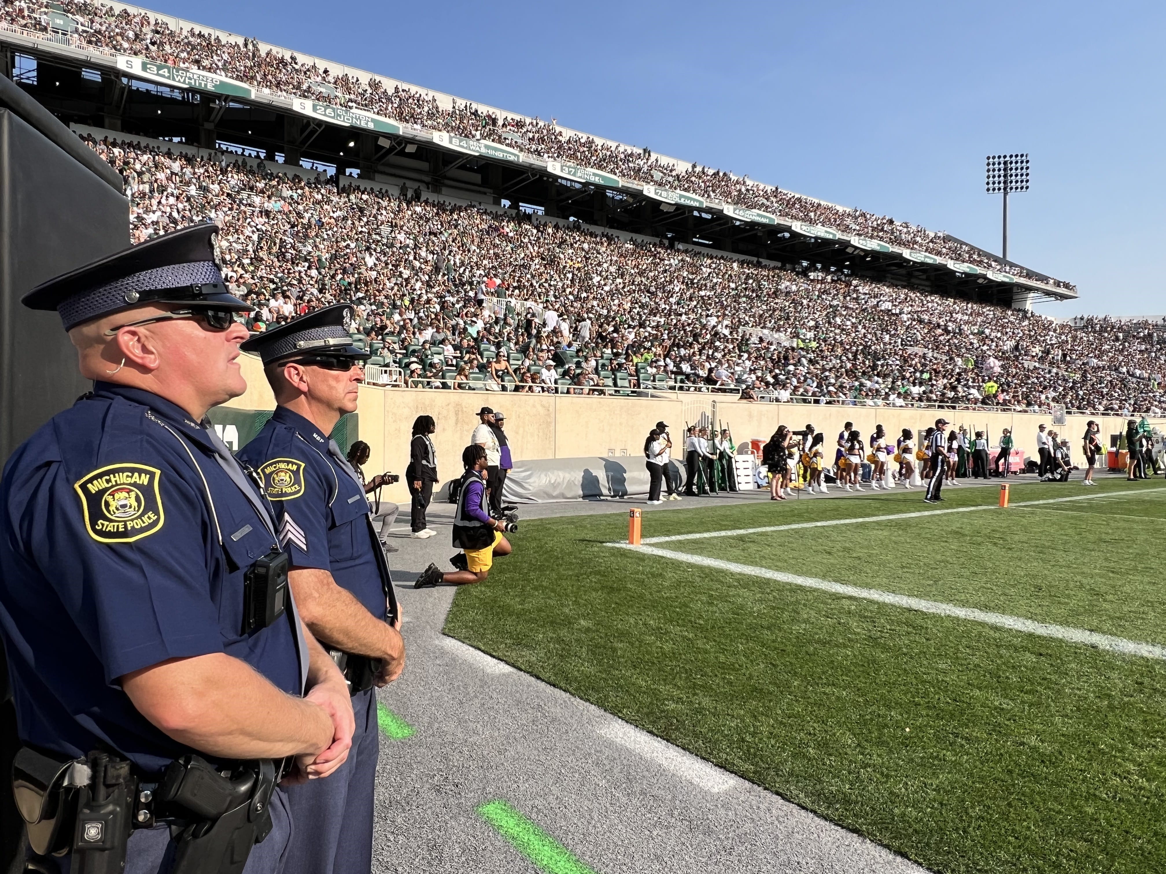 MSP First District Trooper Franklin Carpenter, left, and MSP First District Sgt. Peter Smith assists with security and crowd management at an MSU football game in East Lansing, Mich., Sept. 14, 2024. 