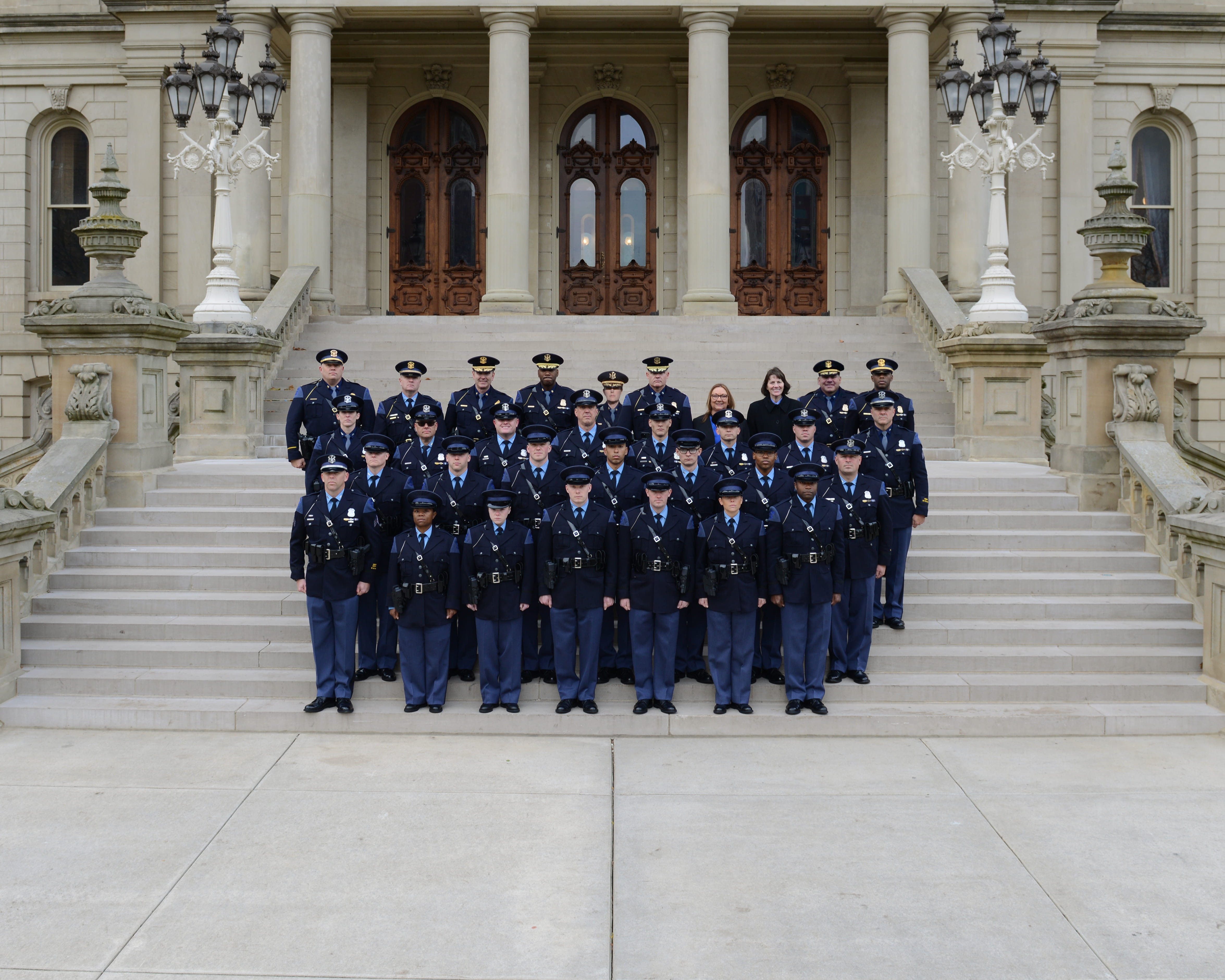 Class of the 27th Motor Carrier Officer Recruit School standing on the Capitol steps with temporary staff and command