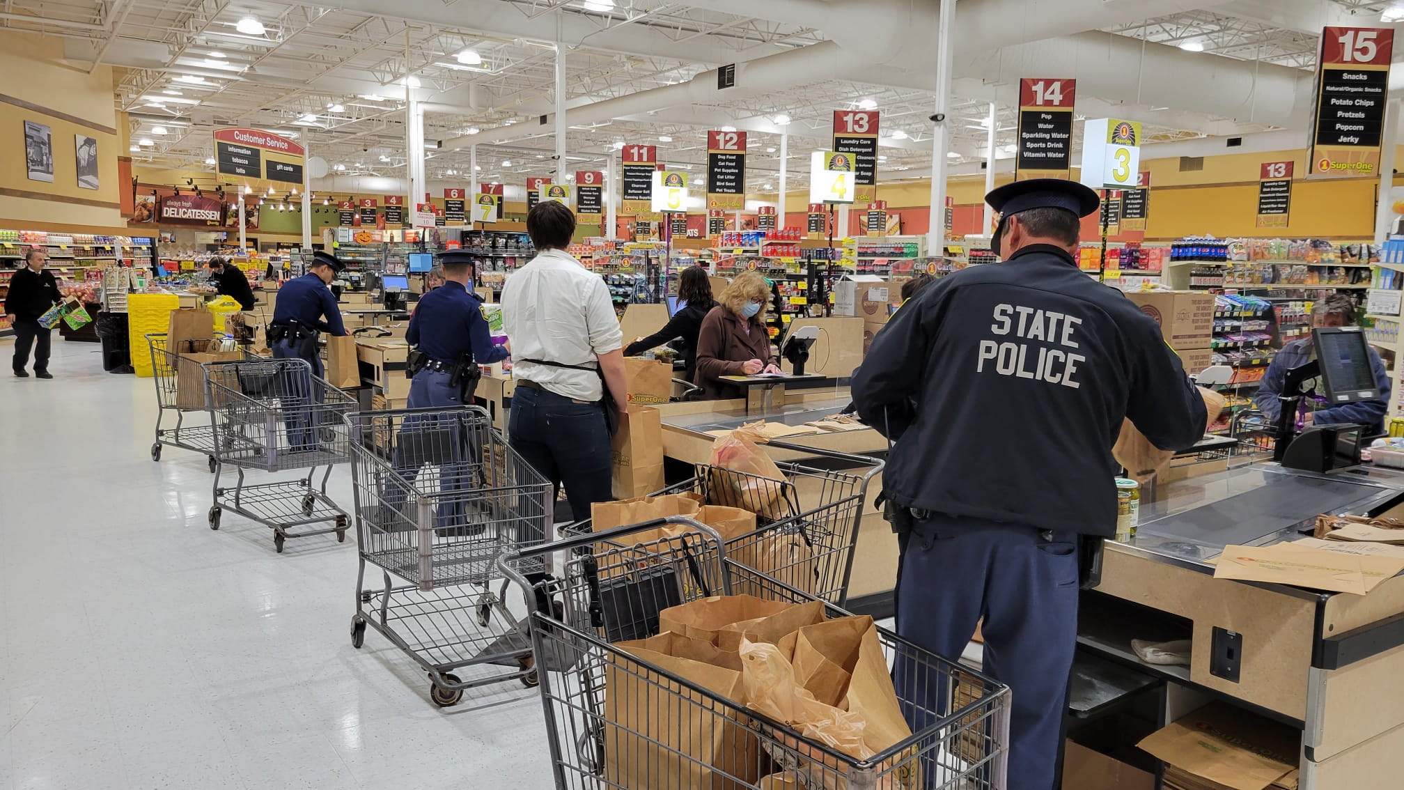 Photo of troopers bagging groceries at Super One