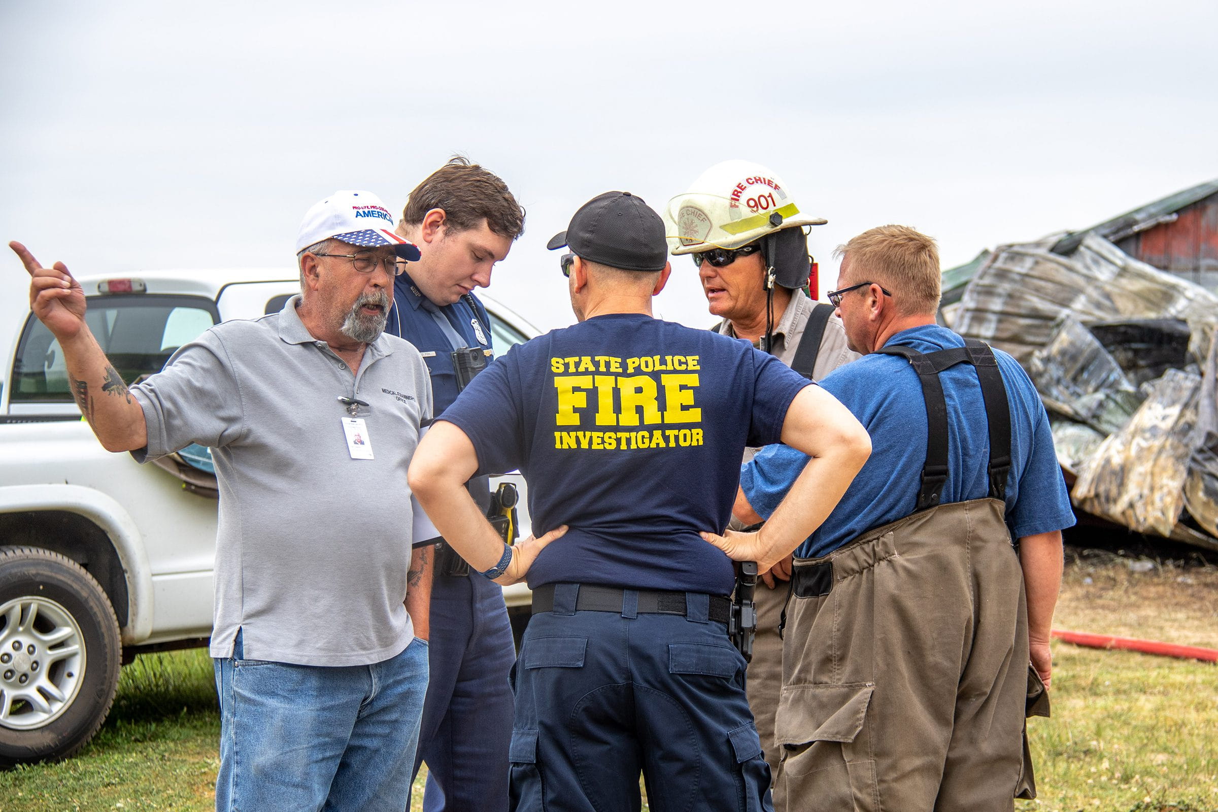 A group of fire investigators outside talking at a scene