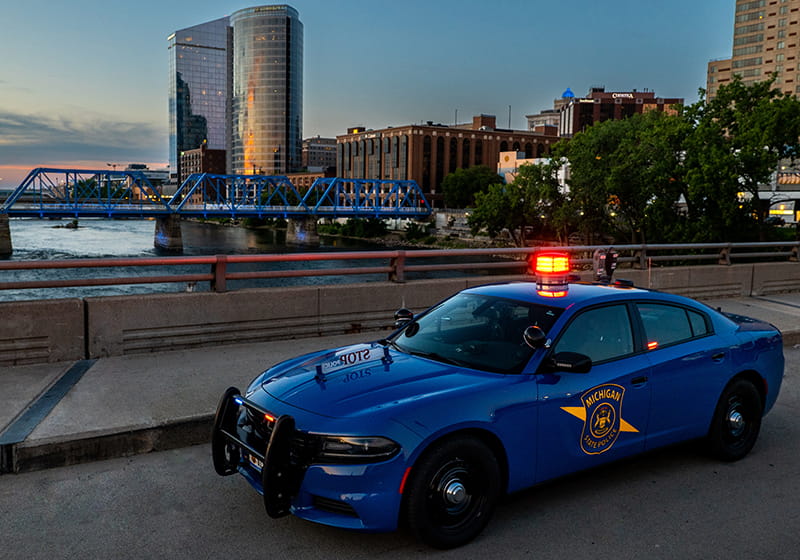 MSP patrol car with city of Grand Rapids behind. 