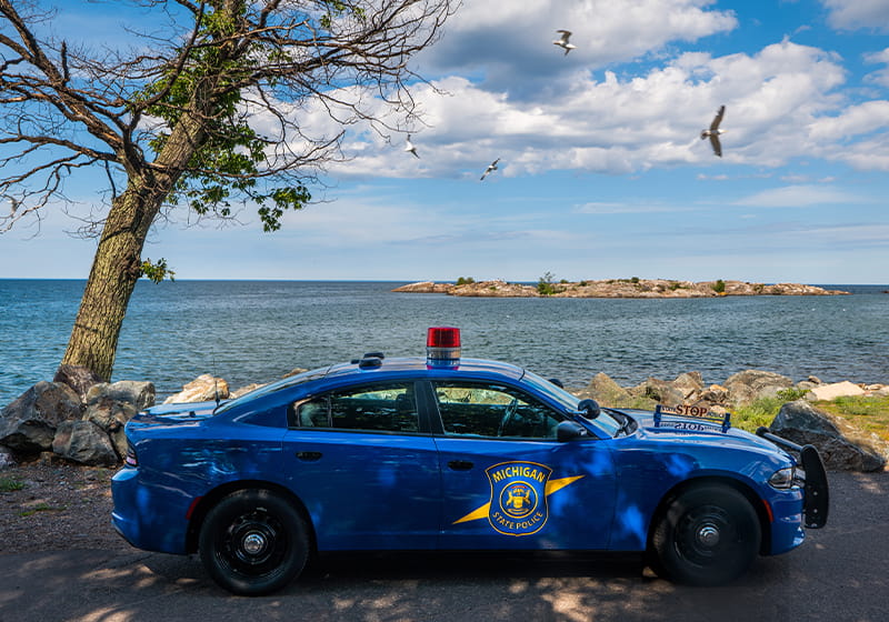 MSP patrol car in front of lake in Marquette. 