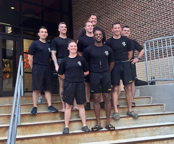 Group photo of Jackson Post troopers standing on steps after helping with football coaching