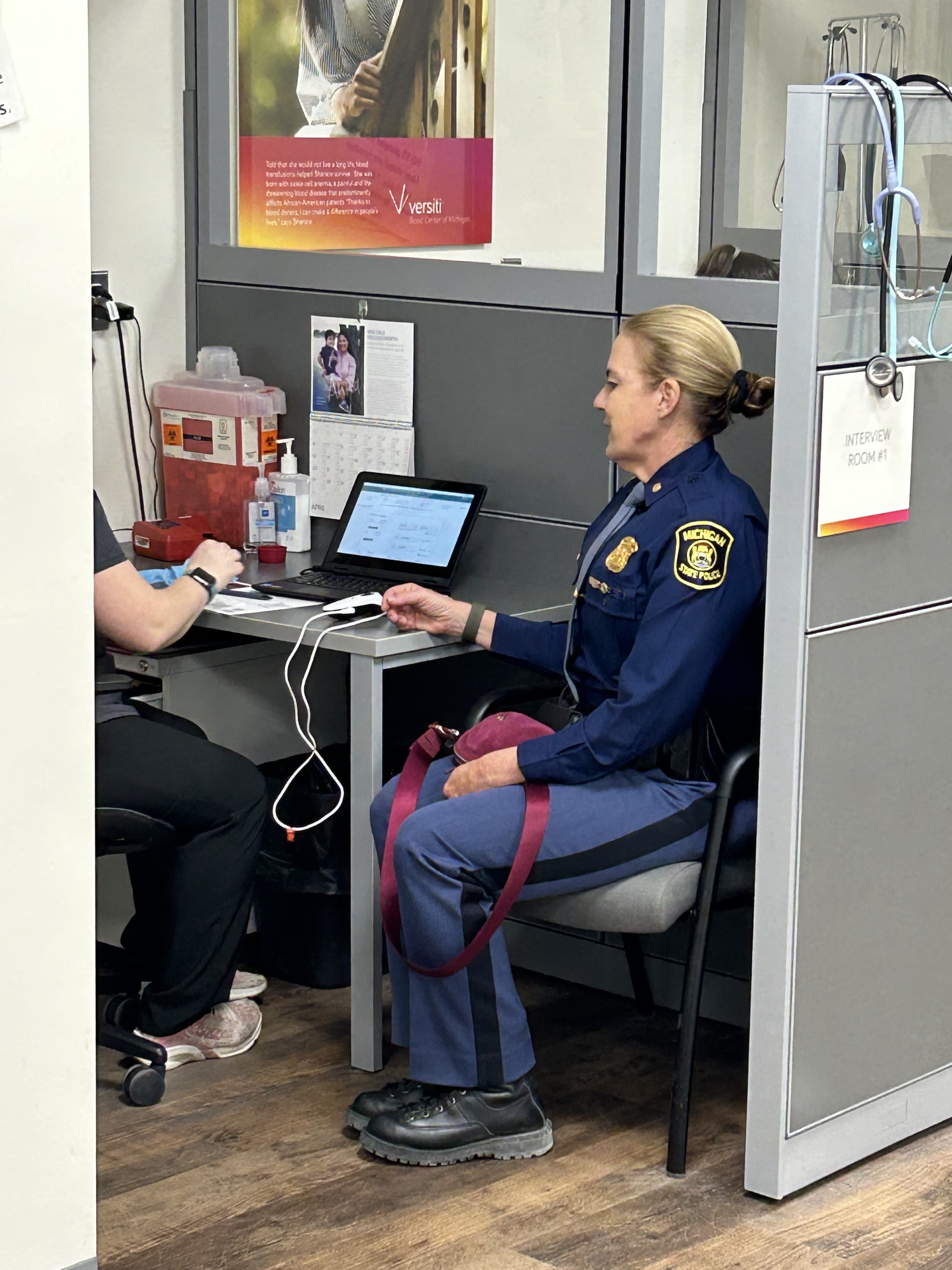 Captain Johnson, commander of the Seventh District, preparing to donate blood